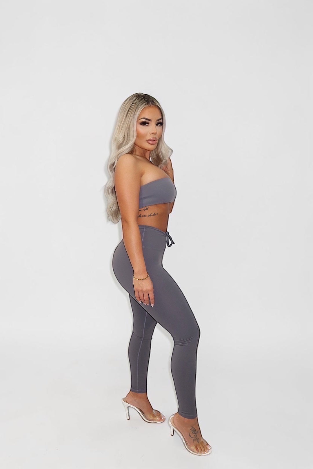 GLAMORZ grey sleeveless tube top worn by a blonde model with matching leggings and clear high heels