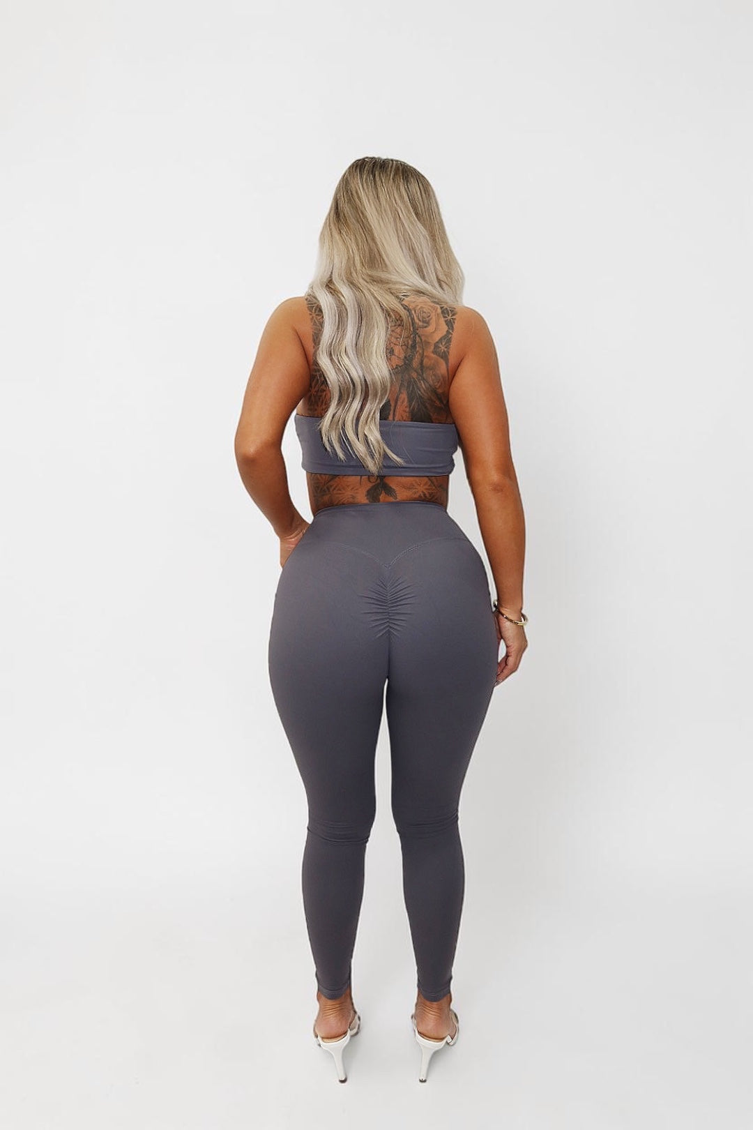 GLAMORZ KHY grey scrunch leggings worn by a blonde model from the back view against a white background