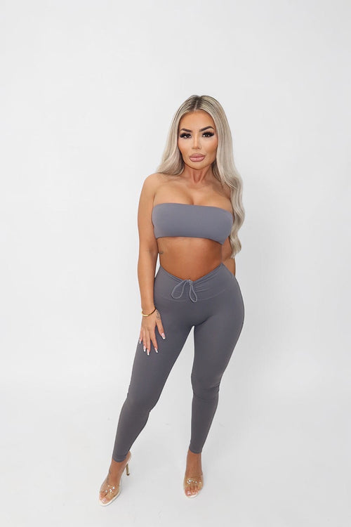 GLAMORZ KHY grey scrunch leggings and matching strapless crop top worn by a blonde model on a white background.