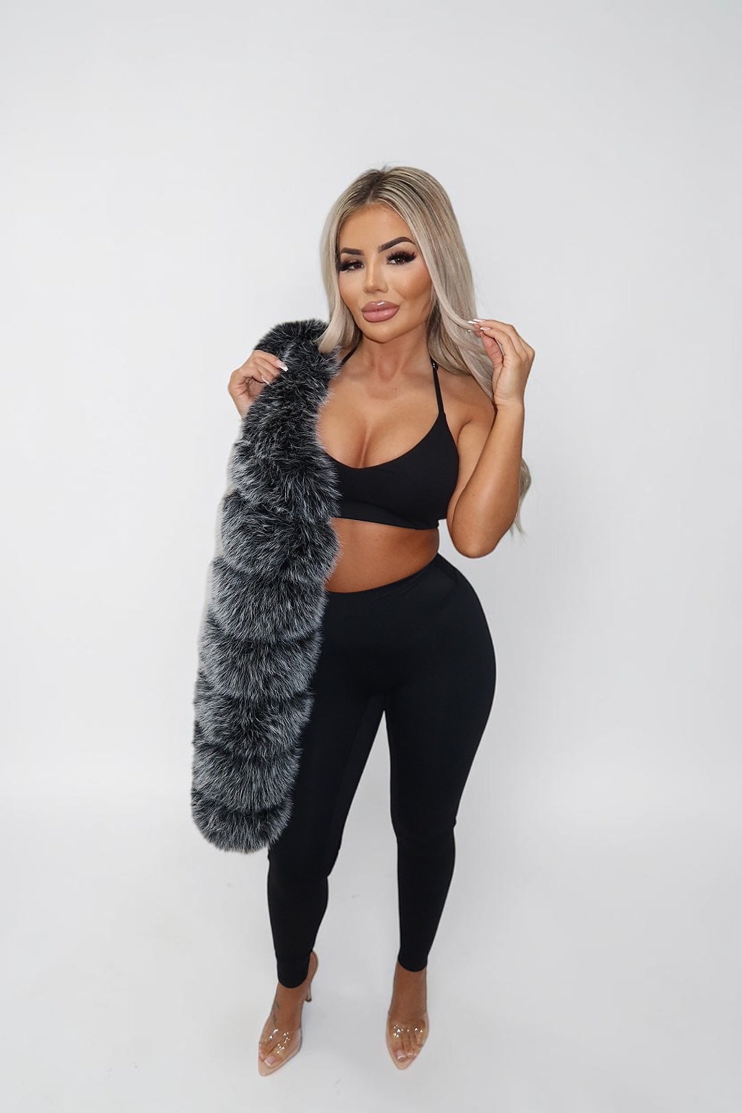 GLAMORZ Sculptra halter bra in black worn by a blonde model with a faux fur stole and matching leggings