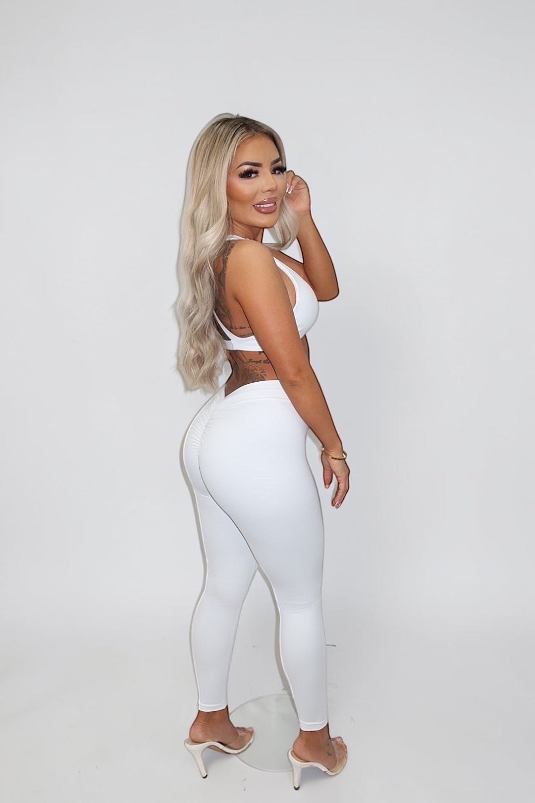 GLAMORZ white BBL bra and matching high-waisted leggings worn by a blonde model against a white background