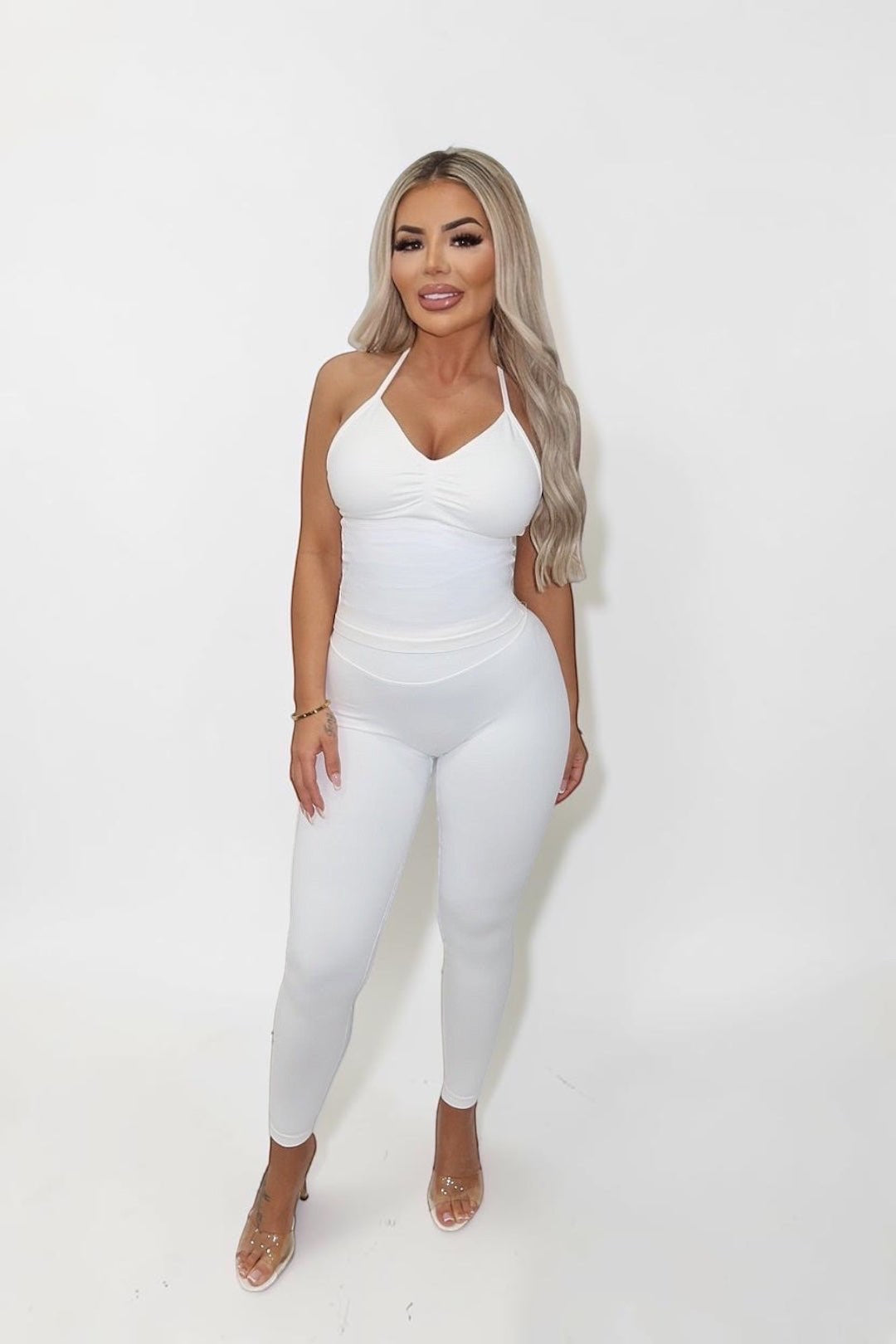GLAMORZ white halter top and matching leggings worn by a blonde model against a plain white background